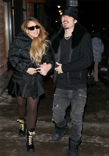 Mariah Carey wears black fur coat, black leggings with a pair of